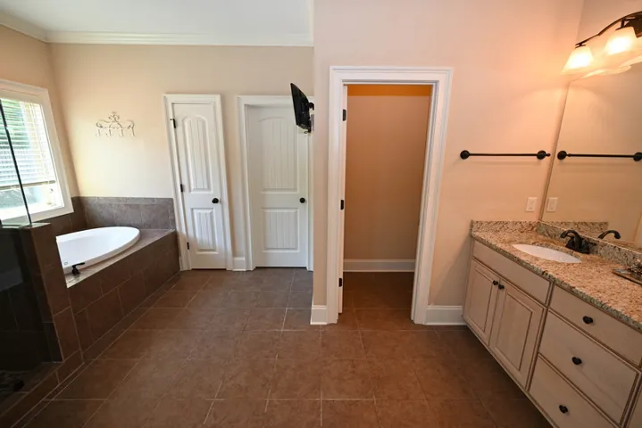 Spacious primary bathroom with an extended double sink vanity.