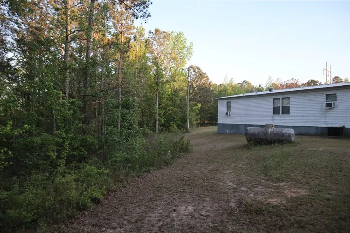 This tranquil setting offers a peaceful escape, surrounded by lush woodlands.