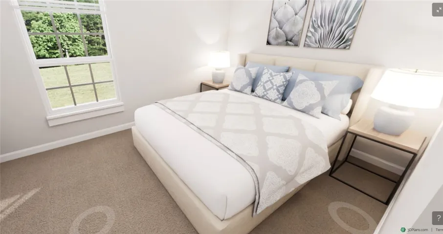 This cozy bedroom features plush carpeting and a large window offering serene outdoor views.