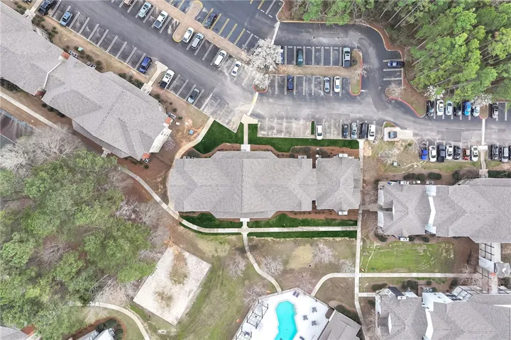An aerial view showcases a residential complex, highlighting its layout and surrounding amenities.