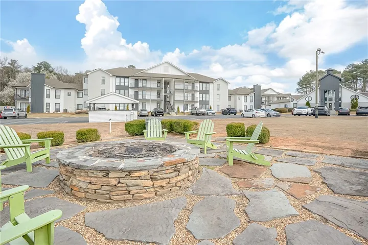 This inviting outdoor space features a stone fire pit, perfect for gatherings.