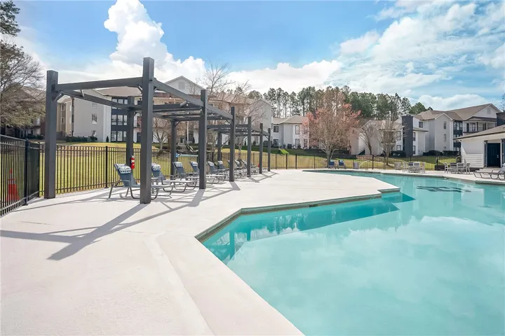 This inviting outdoor space features a pristine pool, perfect for relaxation and leisure.