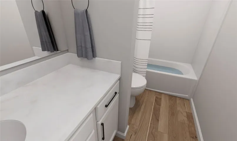 This bathroom features a sleek vanity and a classic tub, offering practical comfort.