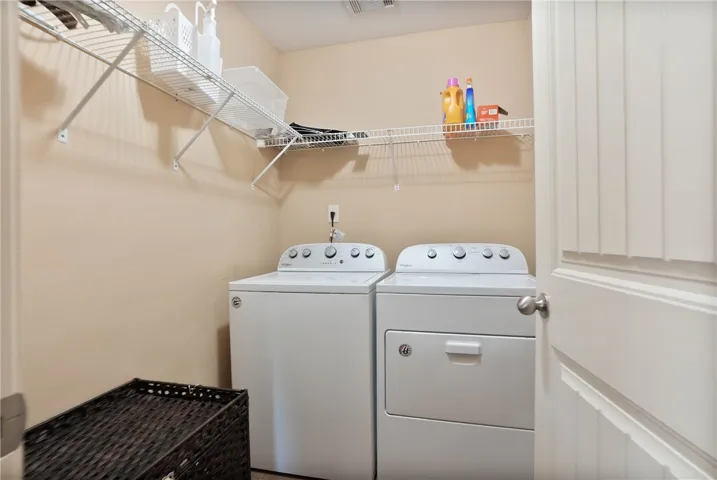 Efficient laundry area with built-in shelving provides practical storage solutions for everyday needs.