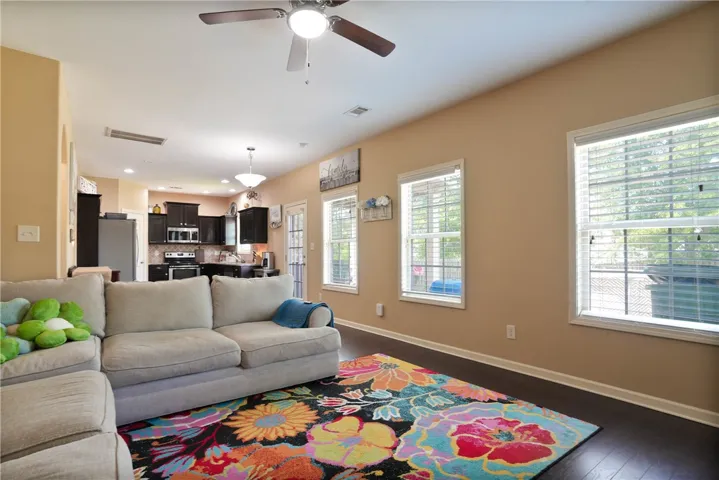 This living area offers a seamless flow into the kitchen, creating an inviting space for daily living.
