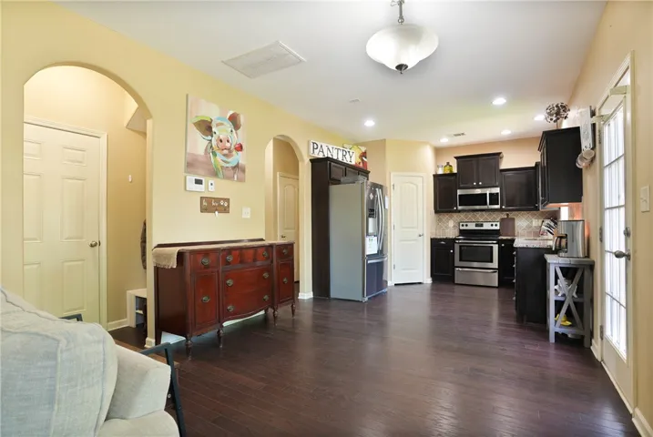 This inviting space combines a functional kitchen with comfortable living, ideal for everyday ease.