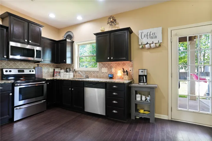This spacious kitchen offers ample cabinet space and modern appliances, perfect for everyday living.
