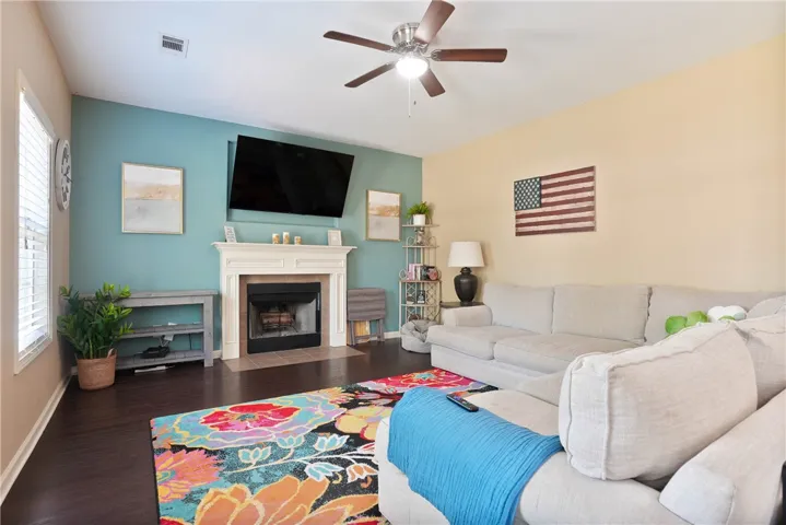 This inviting living room features rich hardwood flooring and a cozy fireplace, perfect for relaxing evenings.