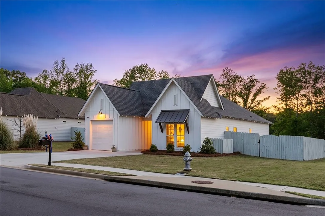 Board and batten siding on this charming home offers appealing curb appeal under a twilight sky.