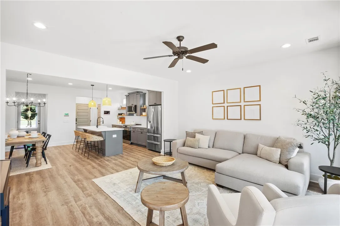 An open-concept living space integrates a stylish kitchen with modern amenities and comfortable seating.