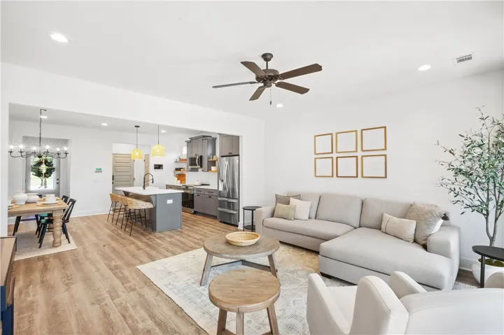 An open-concept living space integrates a stylish kitchen with modern amenities and comfortable seating.