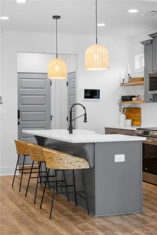 Culinary adventures await in this chic kitchen, featuring an inviting island with seating and sophisticated pendant lighting.