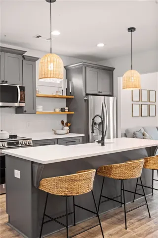 Modern kitchen with sleek cabinetry, a substantial island, and stylish pendant lighting.