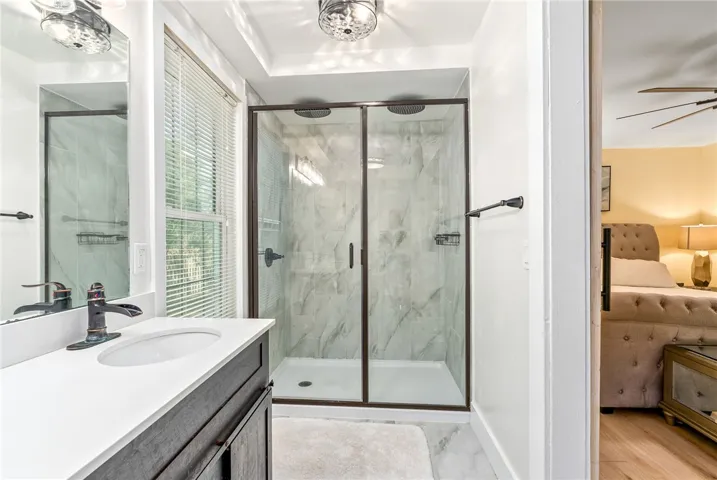 This bathroom showcases a sleek walk-in shower with modern fixtures.