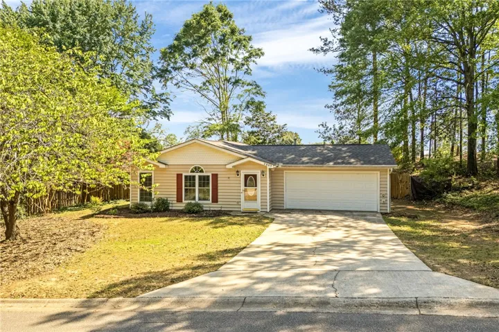 This charming home features a classic design with a welcoming front yard and convenient driveway.