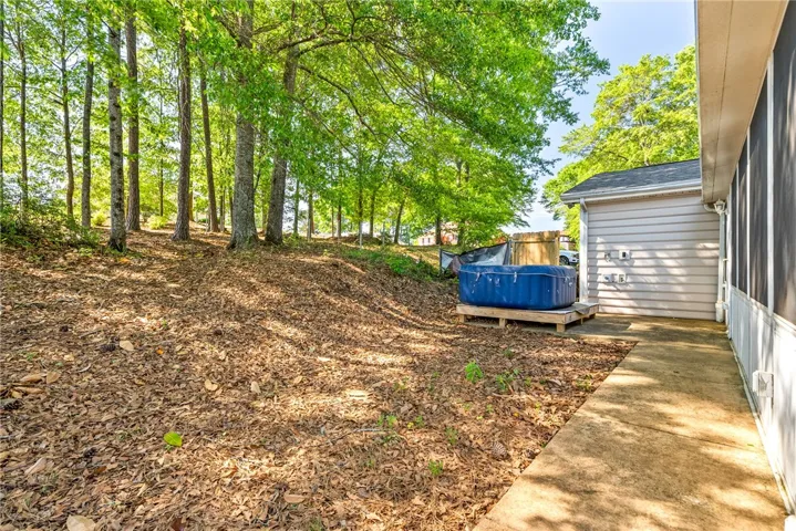 This spacious yard offers a serene natural setting perfect for outdoor enjoyment.