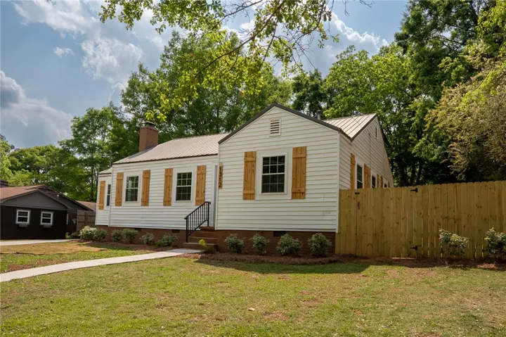 This charming home offers classic appeal with a durable metal roof and a private fenced yard.