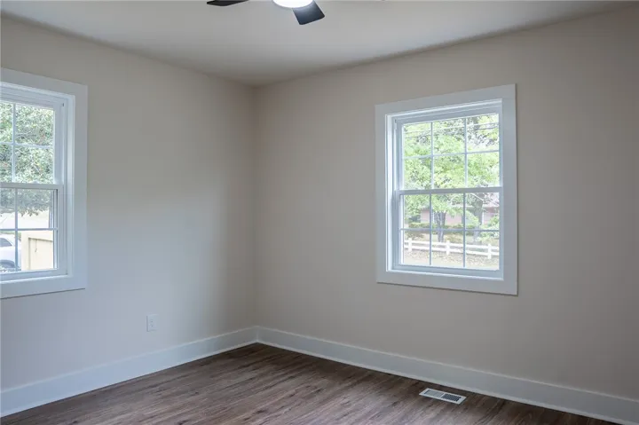 This bright room features durable flooring and ample natural light, creating an inviting atmosphere.