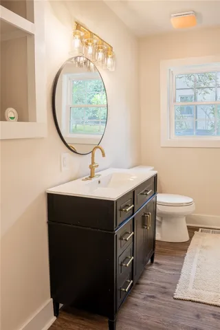 This bright bathroom features a modern vanity and ample natural light.