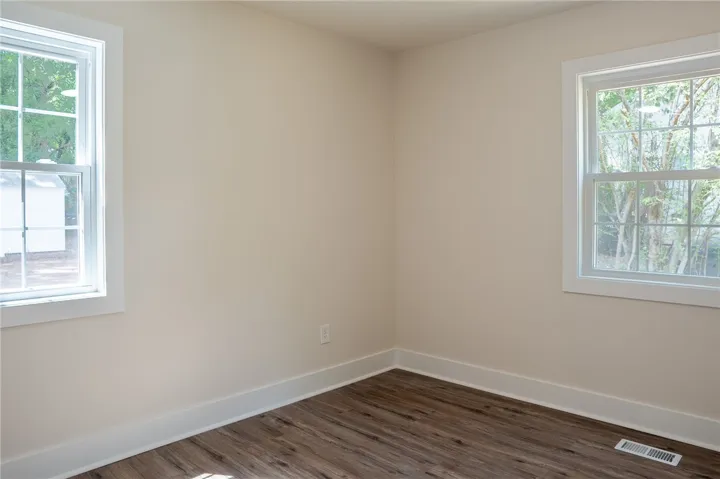 This bright and airy room offers abundant natural light and modern flooring.