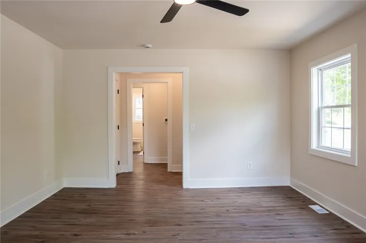 This versatile room features durable flooring and a refreshing ceiling fan.