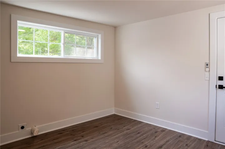 This versatile room features durable flooring and ample natural light, ideal for various uses.