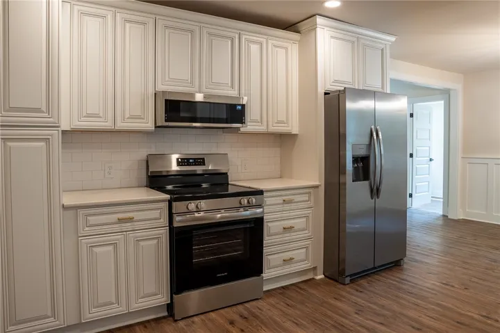 This modern kitchen features new appliances and ample cabinet space.