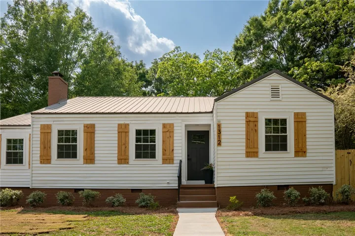 This charming residence features classic siding and a welcoming entryway, offering comfort and style.