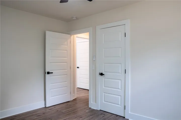 This bright space features sleek flooring and contemporary panel doors, creating a fresh, inviting atmosphere.