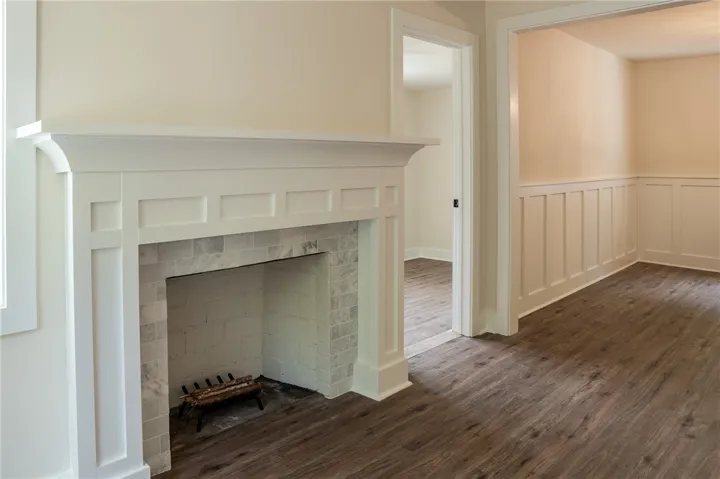 This inviting interior boasts a beautifully crafted fireplace and durable flooring, perfect for comfortable living.