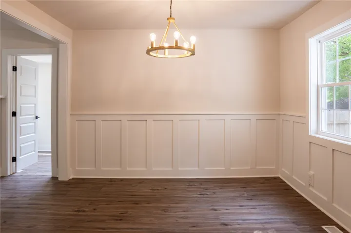 This bright room features classic wainscoting and a chic chandelier.