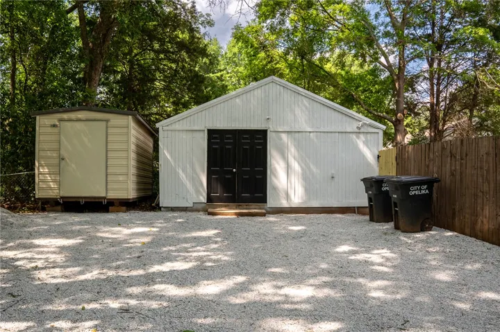 This spacious detached garage and storage shed offer ample utility and convenience.