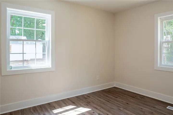 This bright room features beautiful flooring and abundant natural light, creating an inviting atmosphere.