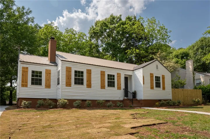 This charming home features a classic exterior with tasteful wood accents and a well-maintained yard.