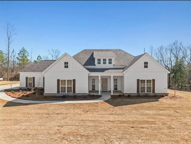 This charming modern farmhouse-style home features a classic exterior and inviting curb appeal.
