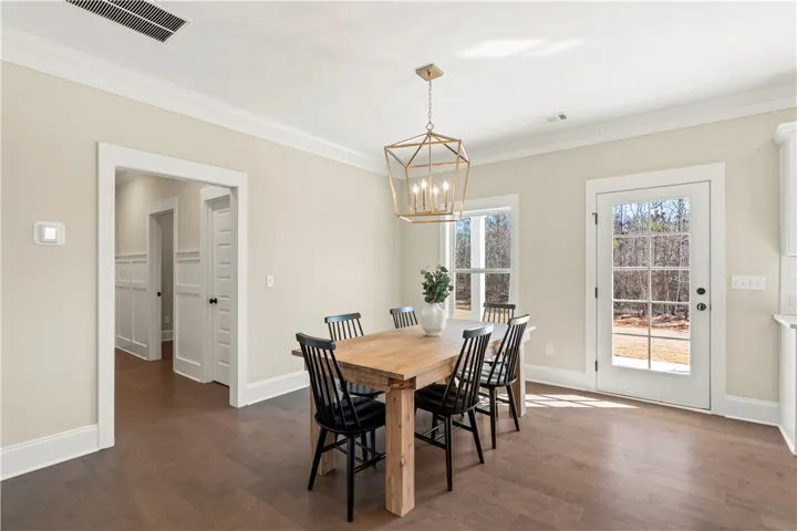 This bright dining area features warm wood flooring and abundant natural light.