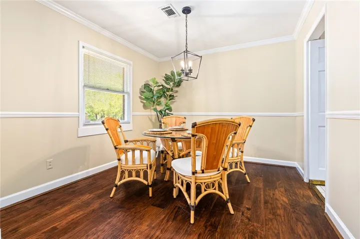 This inviting dining area features elegant hardwood flooring and ample natural light.