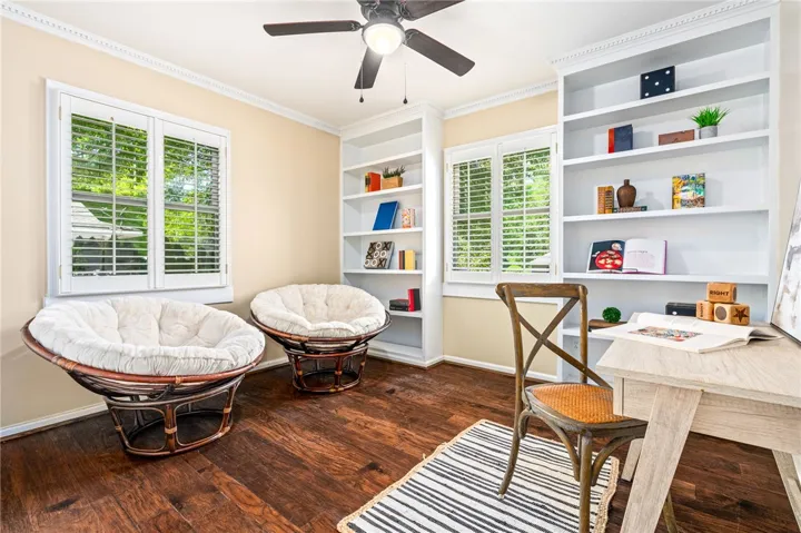 This versatile room features built-in shelving, and hardwood flooring.