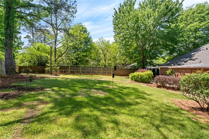 The backyard offers ample space for outdoor enjoyment and serene natural surroundings.