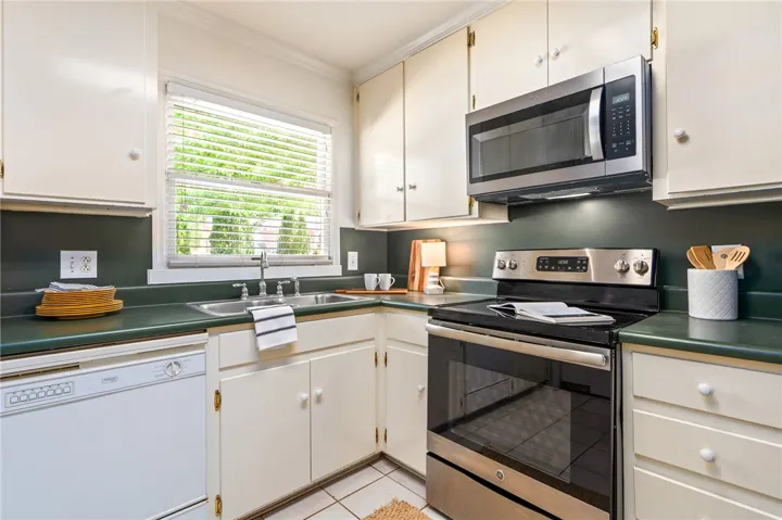 Kitchen space located off dining area and den.
