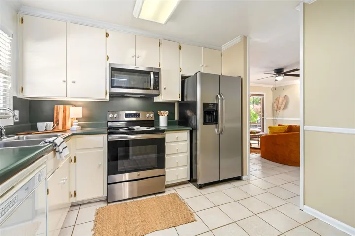 Kitchen space located off dining area and den.