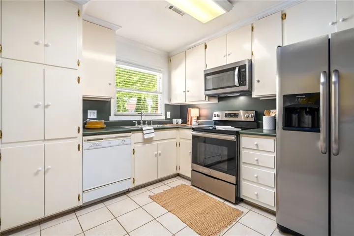 Kitchen space located off dining area and den.