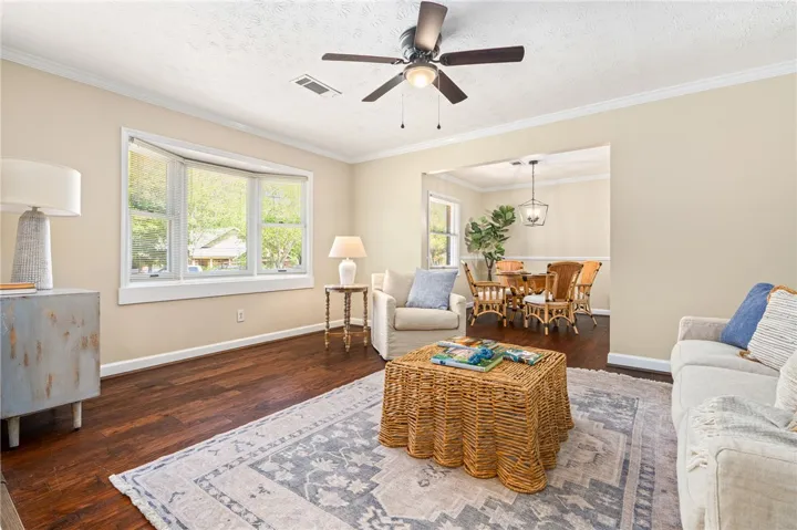 This inviting living space features warm wood floors and ample natural light, perfect for relaxation.