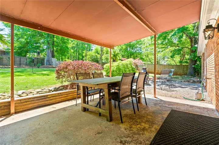 This inviting patio offers a serene outdoor retreat perfect for dining and relaxation.