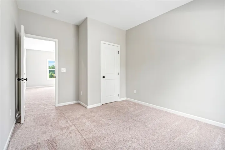 Soft carpeting underfoot defines this comfortable room complete with a classic built-in closet.