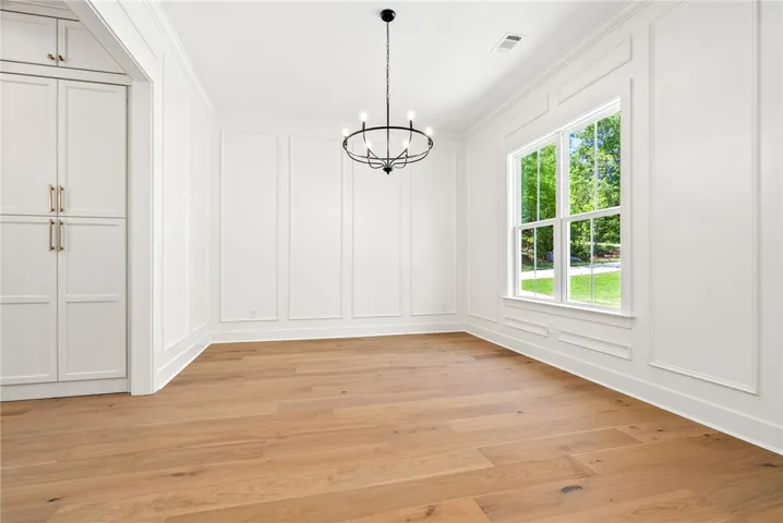 The dining room, finished with floor-to-ceiling millwork, sits at the front of the home with direct access to the kitchen and easy proximity to the foyer.