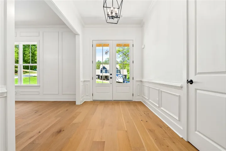 Grand double front doors open to a formal foyer, offering a welcoming introduction to the home beyond.