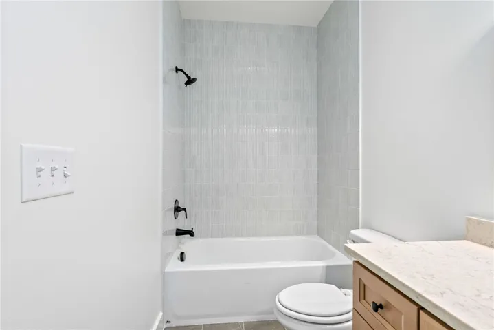 The shower tile in Bath 3 is beautifully detailed, with narrow pieces installed in a vertical pattern.