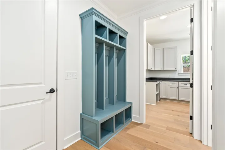 The mud bench at the owner’s entry provides a functional, custom-designed space to keep everyday belongings organized.