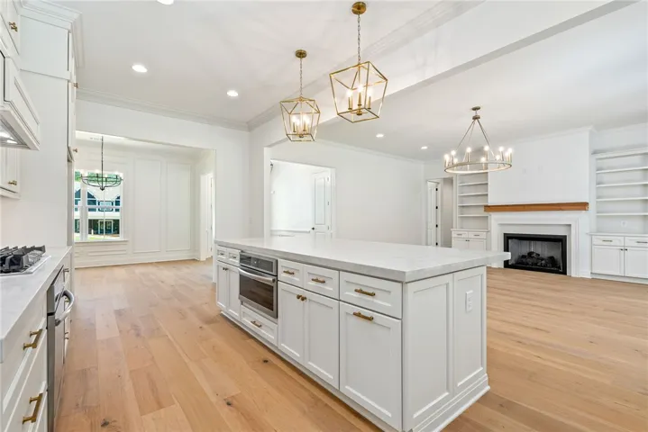 The heart of the home is designed for gathering, with an open floorplan connecting the kitchen, living, and dining spaces.